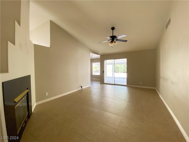 unfurnished living room featuring lofted ceiling, tile patterned flooring, and ceiling fan