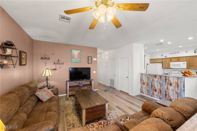 living room featuring ceiling fan and light hardwood / wood-style flooring