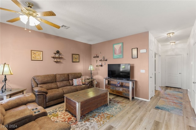 living room with light wood-type flooring and ceiling fan