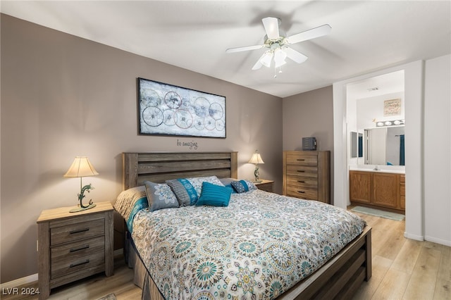 bedroom with light hardwood / wood-style floors, ensuite bathroom, and ceiling fan