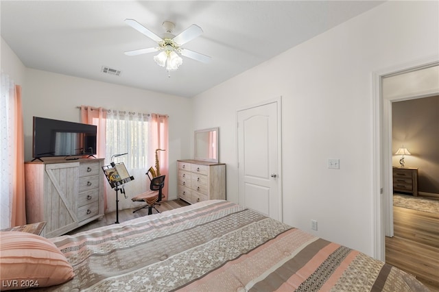 bedroom with hardwood / wood-style flooring and ceiling fan