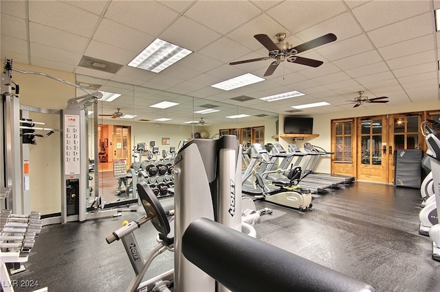 exercise room with a drop ceiling and ceiling fan