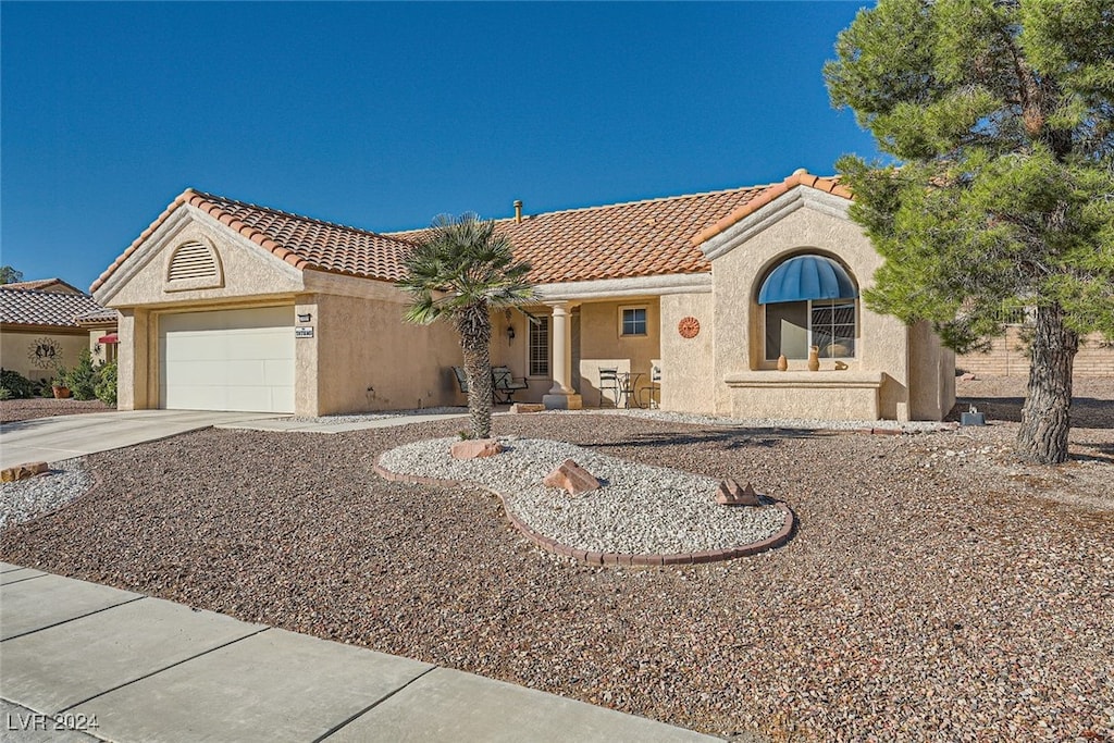 mediterranean / spanish-style house featuring a garage