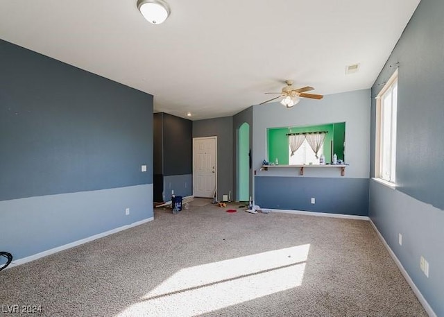 unfurnished room featuring carpet and ceiling fan