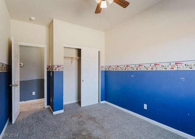 unfurnished bedroom with carpet, a closet, and ceiling fan