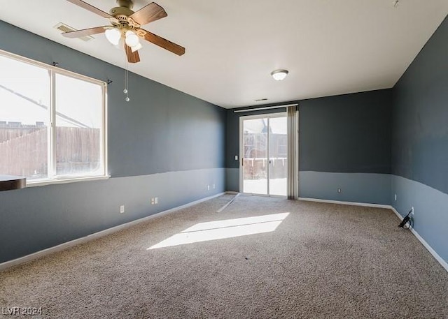 unfurnished room featuring ceiling fan and carpet flooring