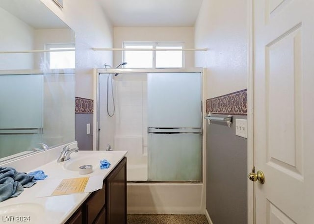 bathroom with vanity and bath / shower combo with glass door