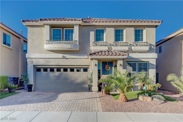 mediterranean / spanish-style home with a balcony and a garage