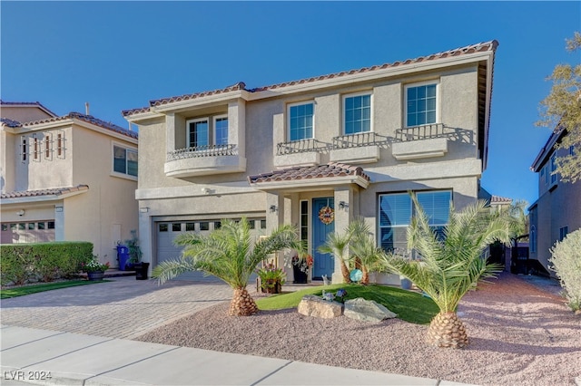 mediterranean / spanish-style home with a garage