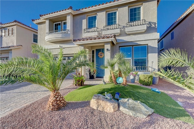 mediterranean / spanish-style home featuring a balcony