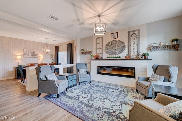 living room featuring light hardwood / wood-style floors and a notable chandelier