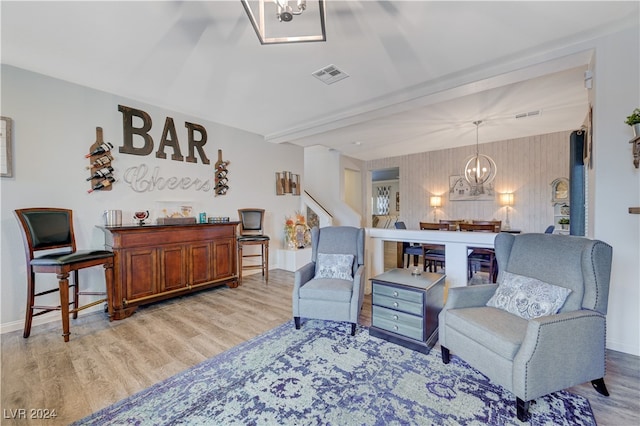 sitting room featuring light hardwood / wood-style flooring and an inviting chandelier