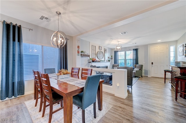 dining room featuring light hardwood / wood-style flooring and a chandelier