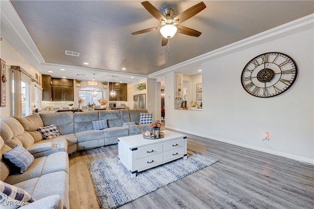 living room with ceiling fan and light wood-type flooring