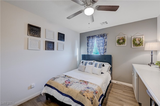 bedroom with ceiling fan and light hardwood / wood-style flooring