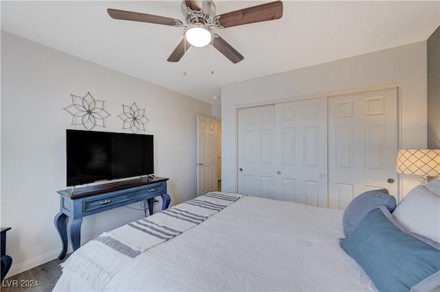 bedroom featuring hardwood / wood-style flooring, ceiling fan, and a closet