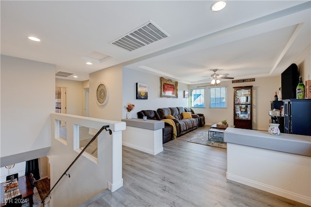 living room with ceiling fan and light hardwood / wood-style flooring