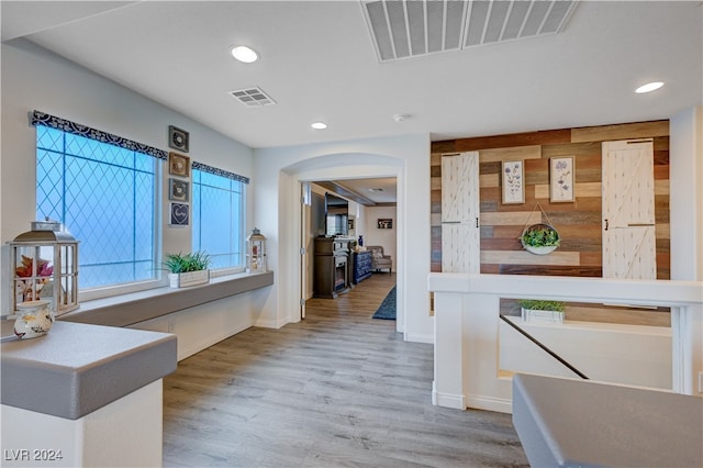 corridor with light hardwood / wood-style flooring