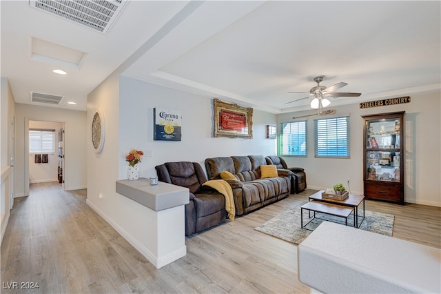 living room featuring ceiling fan, a wealth of natural light, and light hardwood / wood-style flooring