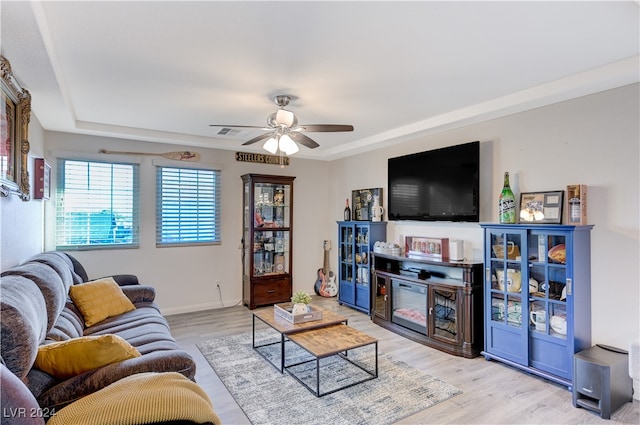 living room featuring ceiling fan and light hardwood / wood-style floors