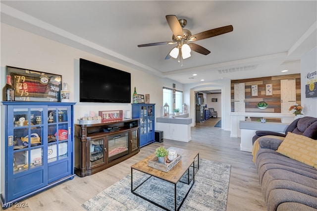 living room featuring ceiling fan and light hardwood / wood-style flooring