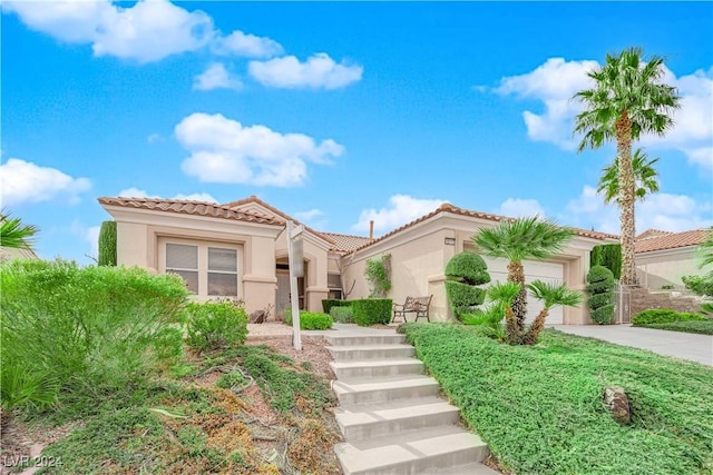 mediterranean / spanish house featuring a garage