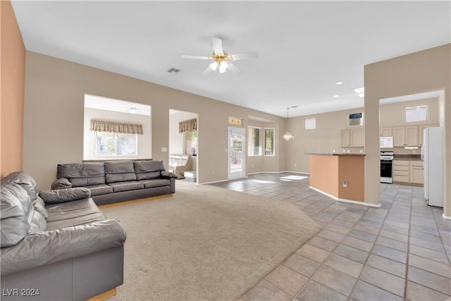 living room with ceiling fan and light tile patterned floors