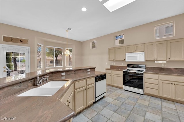 kitchen featuring a notable chandelier, white appliances, decorative light fixtures, and cream cabinets