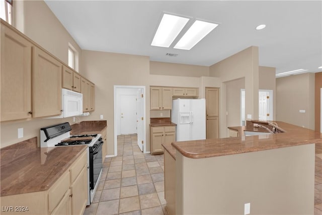 kitchen featuring light brown cabinets, white appliances, and sink