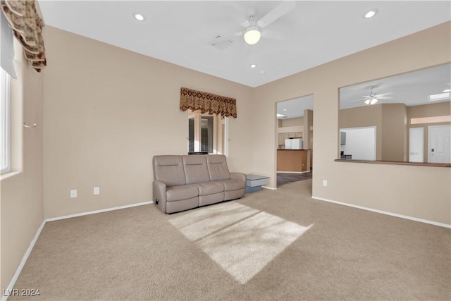 carpeted living room featuring ceiling fan