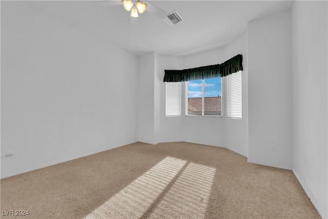 unfurnished room with ceiling fan and light carpet