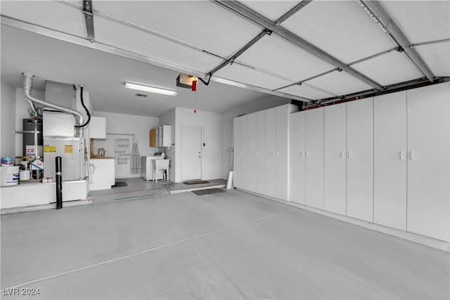 garage featuring a garage door opener and water heater