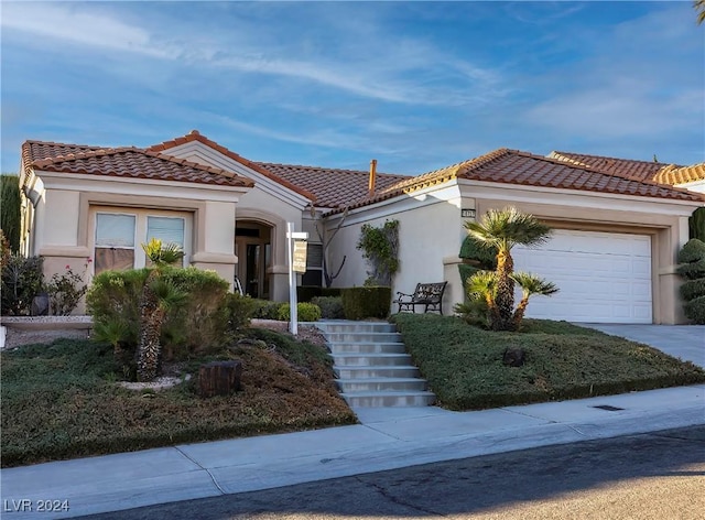 mediterranean / spanish-style home featuring a garage