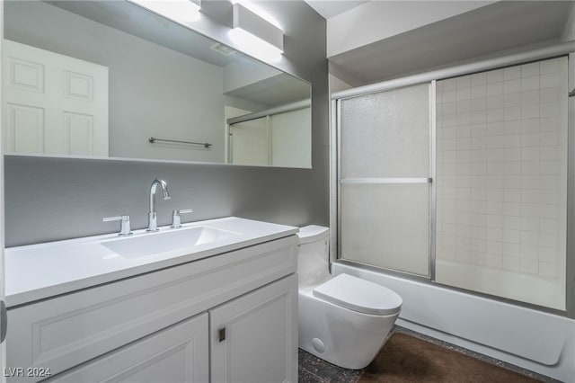 full bathroom with vanity, enclosed tub / shower combo, and toilet