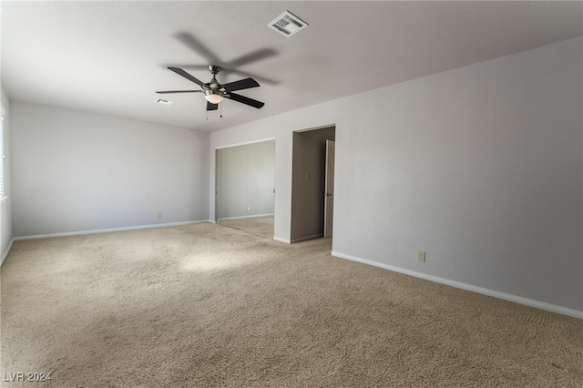 unfurnished bedroom with light colored carpet and ceiling fan