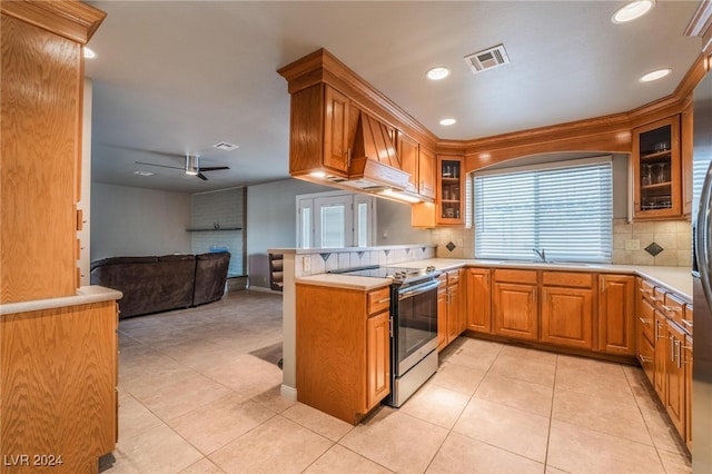 kitchen featuring ceiling fan, decorative backsplash, stainless steel electric range oven, light tile patterned floors, and kitchen peninsula