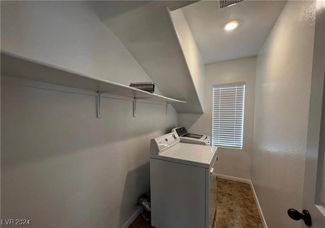 clothes washing area with washing machine and dryer