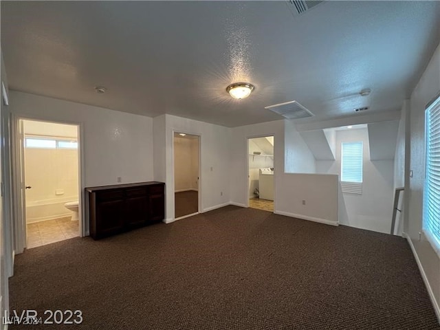 bonus room featuring carpet, plenty of natural light, and washer / clothes dryer