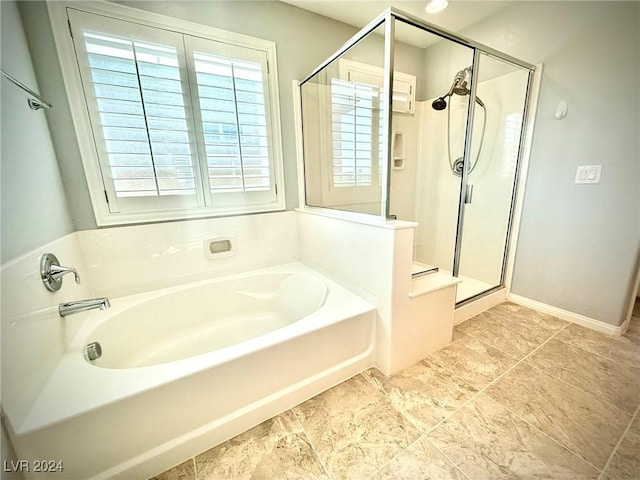 bathroom featuring separate shower and tub