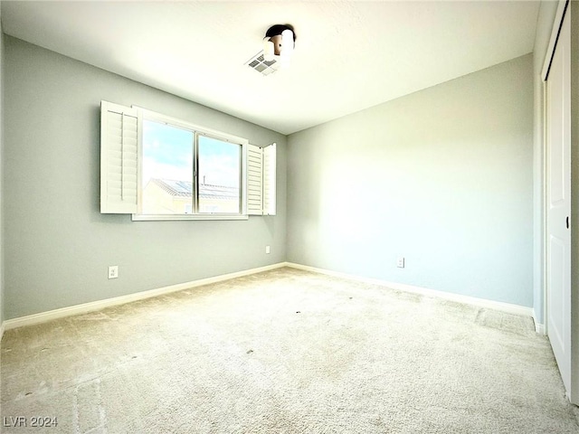 empty room with light colored carpet