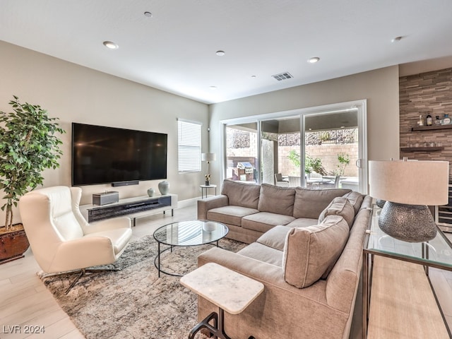 living room featuring a healthy amount of sunlight and light hardwood / wood-style flooring