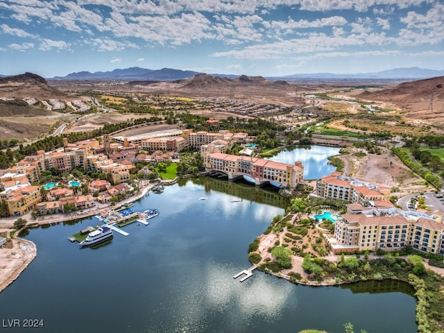 birds eye view of property with a water and mountain view