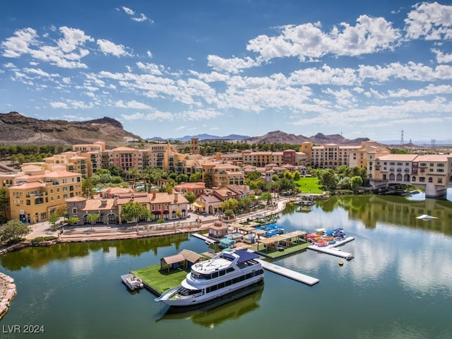 birds eye view of property featuring a water and mountain view