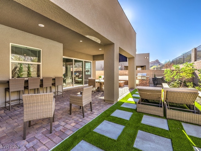 view of patio with outdoor lounge area, area for grilling, and grilling area