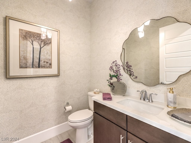 bathroom with toilet and vanity