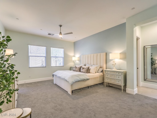 bedroom with ceiling fan and light colored carpet