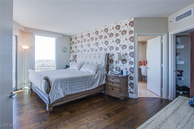 bedroom with dark hardwood / wood-style flooring