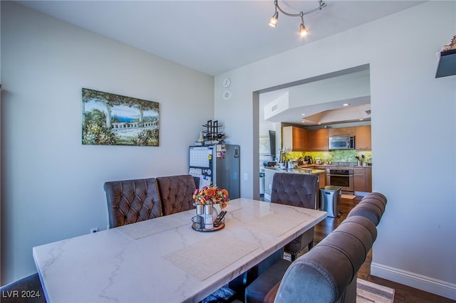 dining area with dark hardwood / wood-style flooring