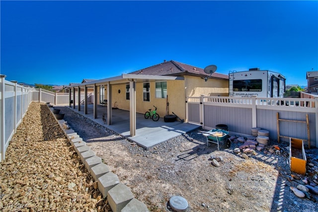 rear view of property featuring a patio area