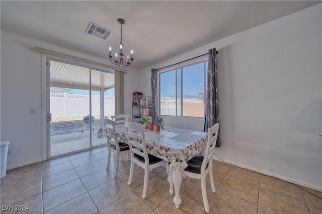 dining room featuring a chandelier and light tile patterned flooring